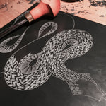 Cutting the lino for the Snake Lino Print by Hex Cavelli