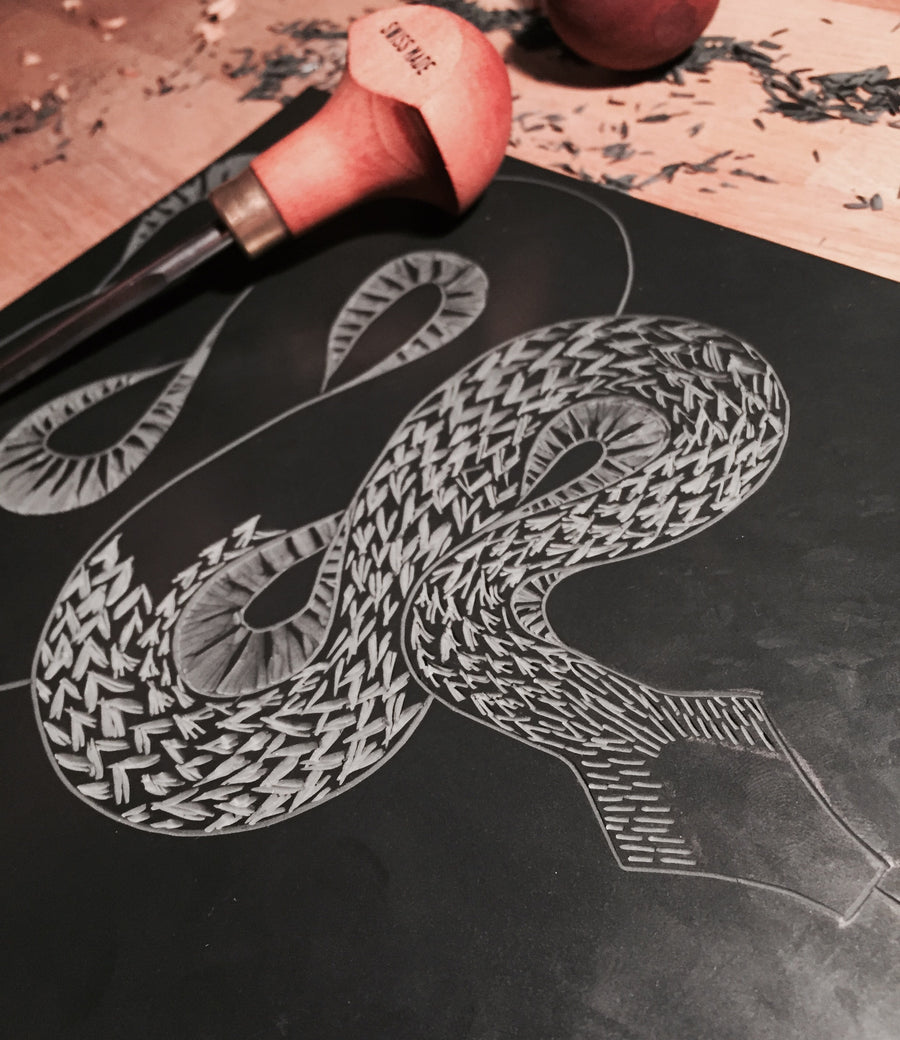 Cutting the lino for the Snake Lino Print by Hex Cavelli
