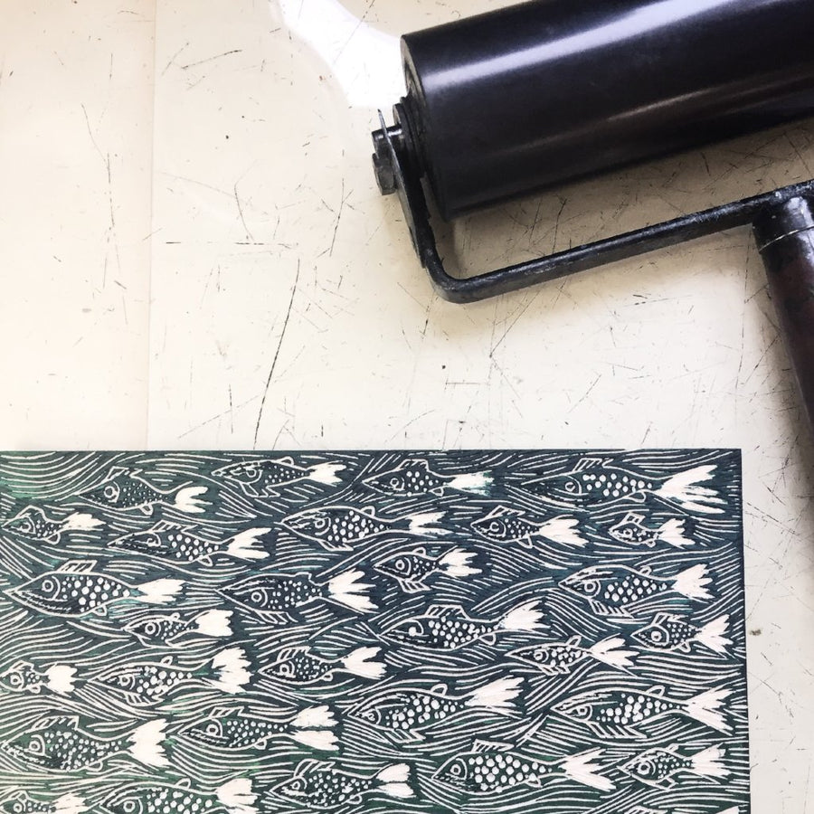 Woodcut and roller ready for printing