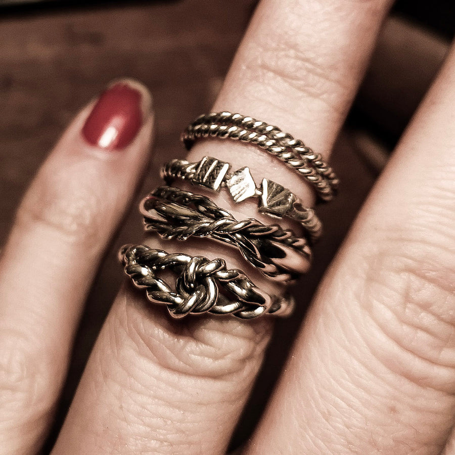 Corssed rope ring on a finger as a stack ring. Nautical knots